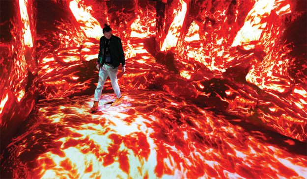 Immersive room with flames projected on the floor and walls.